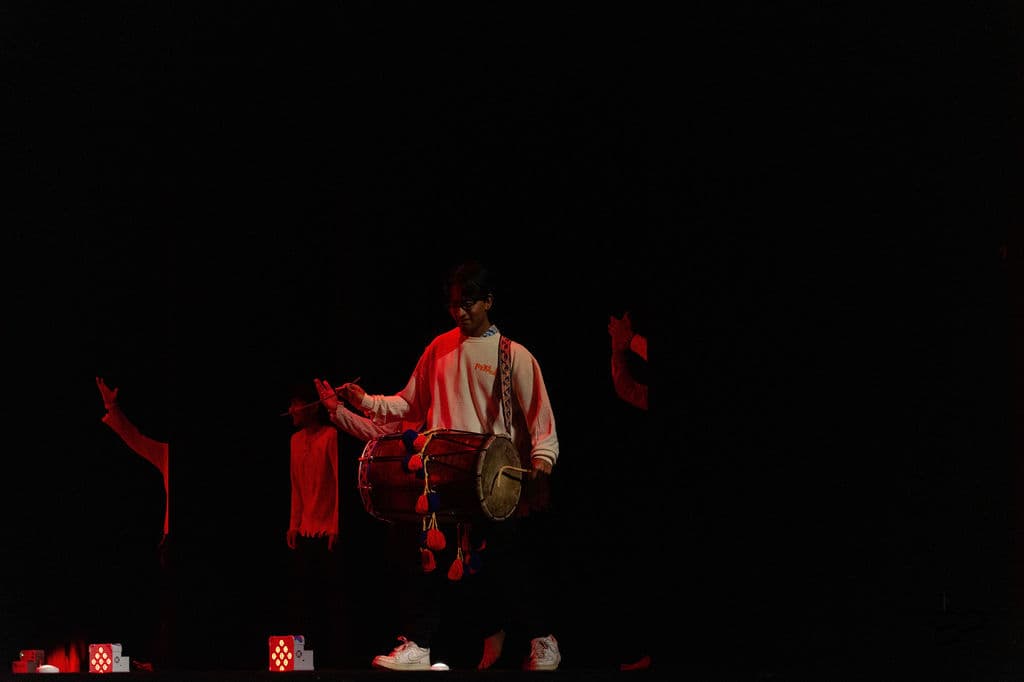 Dhol player performing on stage